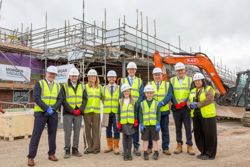 Staff, councillors and pupils are pictured wearing high-viz jackets and hard hats at the site of Chuter Ede Primary School, near Newark.