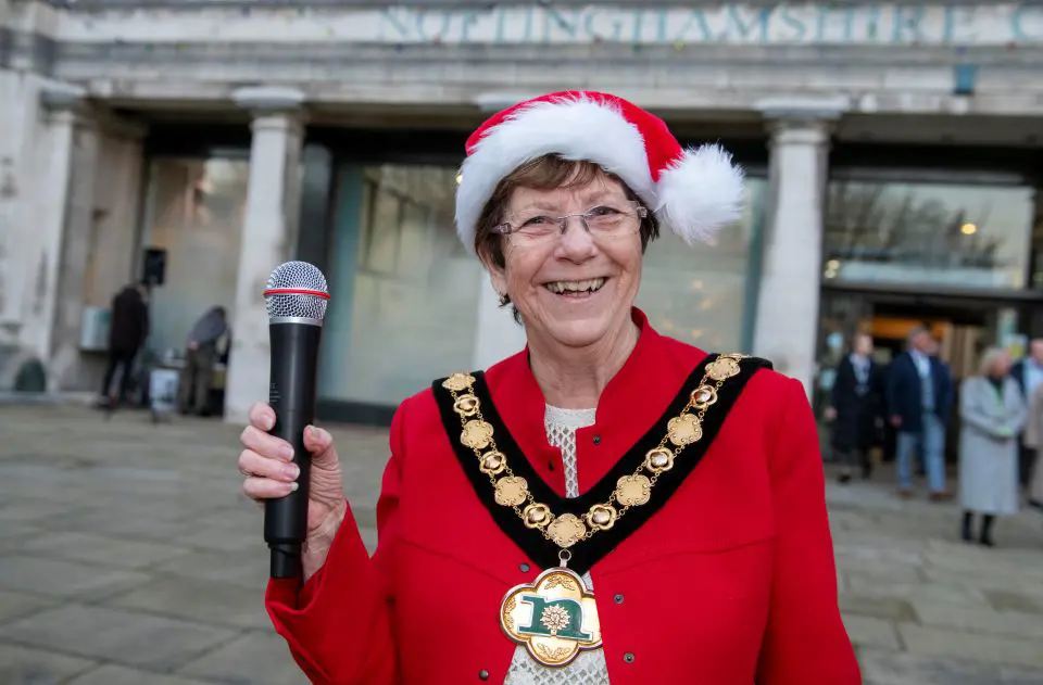 Nottinghamshire County Council Madam Chairman Cllr Jan Goold smiling and holding a microphone