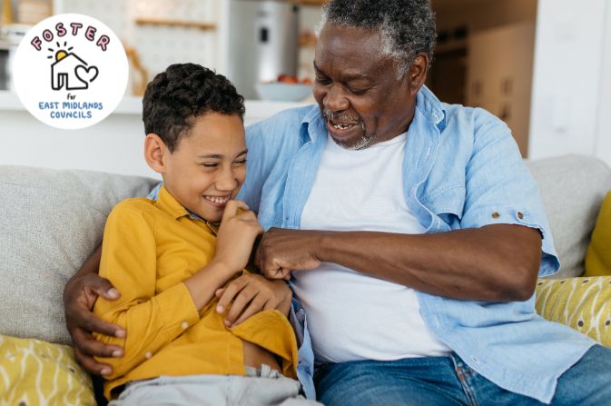 Foster Carer with foster child sat on the sofa