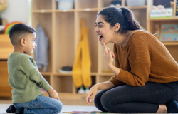 A SEND practitioner in a speech therapy session with a child